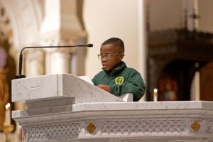 Cathedral High School student reads sacred scripture from the ambo of the Cathedral of the Holy Cross