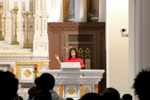 Fatima Caceres '20 proclaims a reading from Sacred Scripture during Mass
