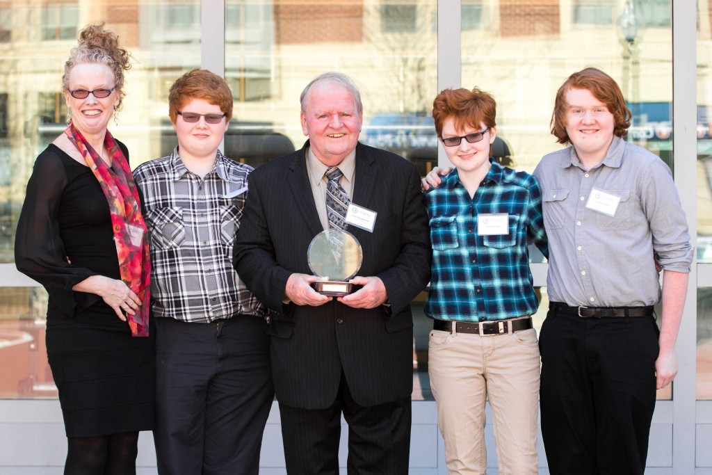 Award Recipient Robert Monahan '65 stands with his family after receiving the St. Joseph the Worker Alumni Award on April 11